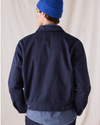 Back view of model wearing Navy Blue Dockers® x Transnomadica Mechanics Jacket.