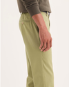 Side view of model wearing New British Khaki Signature Iron Free Khakis, Skinny Fit with Stain Defender®.